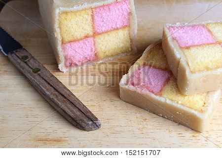 Freshly Cut Battenberg Cake Slices With Knife. Pink And Yellow Sponge Covered In Marzipan