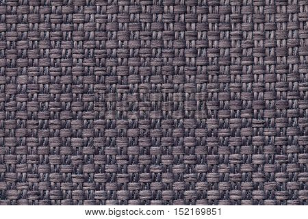 Dark brown background with checkered pattern closeup. Structure of the fabric macro.