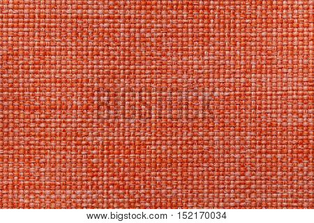 Bright orange background with checkered pattern closeup. Structure of the fabric macro.