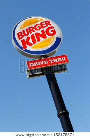 Eskilstuna, Sweden - June 14, 2014: Burger King Drive in road sign against blue sky at the restaurant located at the Vasterleden. Photographed vertically and slightly diagonal.