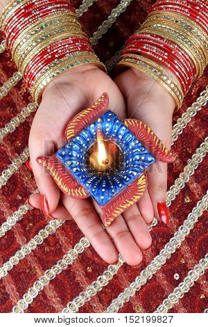 Indian Festival Diwali Diya Lamp Light in Female Hand