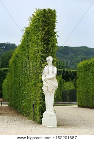Statue on a path of Versailles garden Paris France