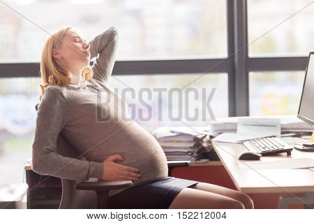 pregnancy, business, gestosis and people concept - pregnant businesswoman feeling sick at office work
