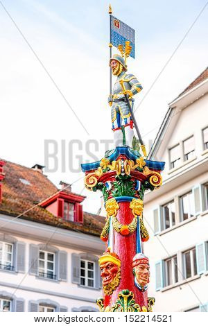 Colorful old fountain statue on the Kapell square in the old town of Lucerne city in Switzerland