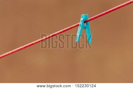 Blue clip on a  red string representing uniqueness