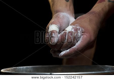 Closeup of male hands with talc powder. young sportsman preparing for workout in gym.