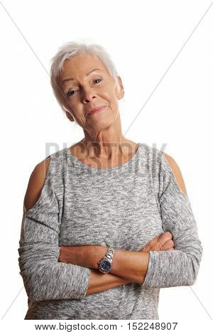 confident mature woman with arms folded and head tilted. isolated on white.