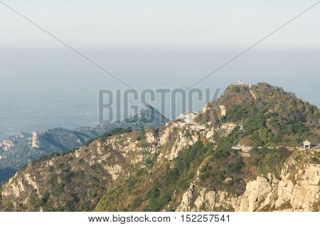 The summit of Taishan or mount Tai above the city of Tai'an in Shandong province on a sunny morning.