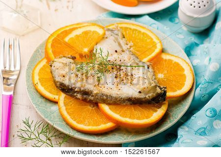 Orange Halibut Steaks on blue plate.seletive focus