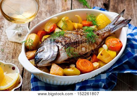 Oven Baked Fish and Vegetables. seletive focus