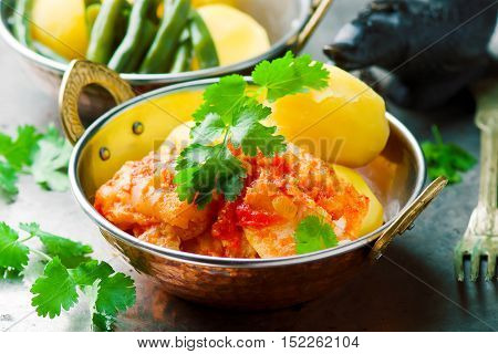 Poached Fish in Tomato Sauce. seletive focus