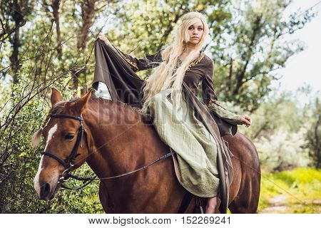 Elf woman in the forest with a horse