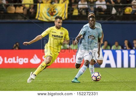 VILLARREAL, SPAIN - OCTOBER 16th: Pape with ball and Mario during La Liga soccer match between Villarreal CF and R.C. Celta de Vigo at El Madrigal Stadium on October 16, 2016 in Villarreal, Spain