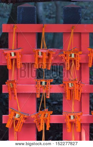 Kyoto Japan - September 17 2016: Closeup of nine wooden prayer boards in the shape of Torii at Fushimi Inari Taisha Shinto Shrine. Left by worshipers writing down their wishes and pleas for the spirits of the ancestors.