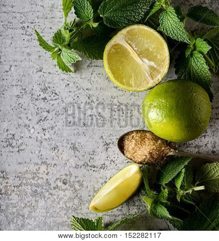 ngredients for making mojitos (ice cubes, mint leaves, sugar and lime on rustic background)