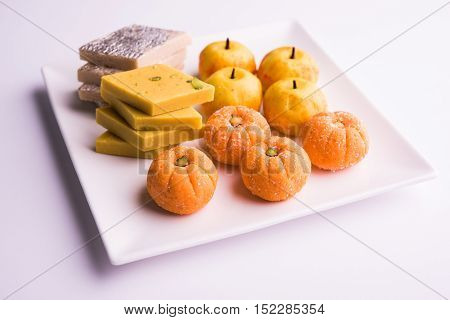 almond, pista, mango and orange flavoured pedha and burfi Indian sweet dish made from milk , dry fruits and fruits, diwali food