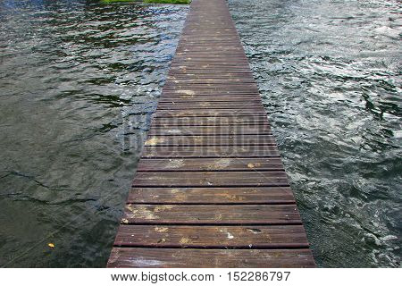 long floating pier from the decking on the lake cost with bird droppings