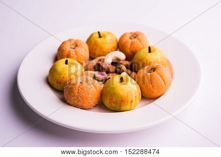 almond, pista, mango and orange flavoured pedha and burfi Indian sweet dish made from milk , dry fruits and fruits, diwali food
