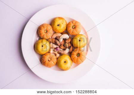 almond, pista, mango and orange flavoured pedha and burfi Indian sweet dish made from milk , dry fruits and fruits, diwali food