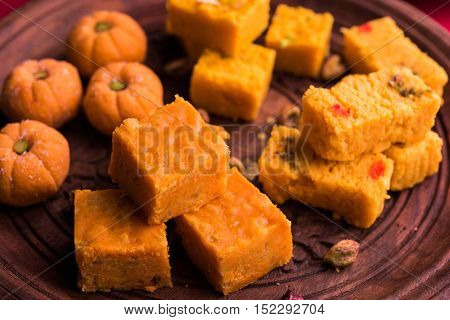 almond, pista, mango and orange flavoured pedha and burfi Indian sweet dish made from milk , dry fruits and fruits, diwali food