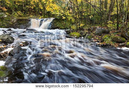 Root Beer Falls in Wakefield Michigan. Tannin rich waters flow over this waterfall in the Upper Peninsula of Michigan during autumn