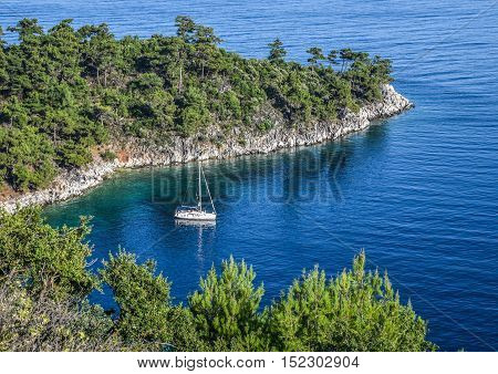 Yacht anchored in the blue waters of a bay in the Mediterranean