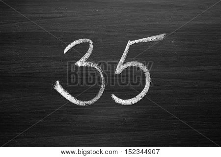 number thirty five enumeration written with a chalk on the blackboard