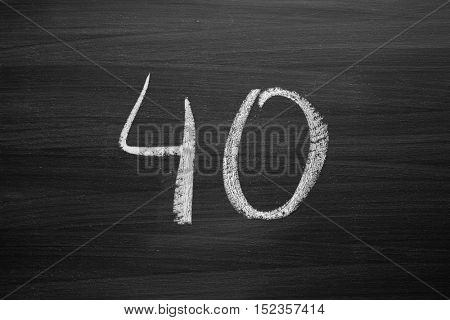number forty enumeration written with a chalk on the blackboard