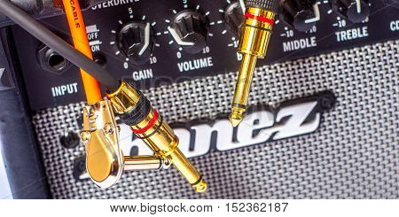 close-up of guitar amplifier with jack cable.