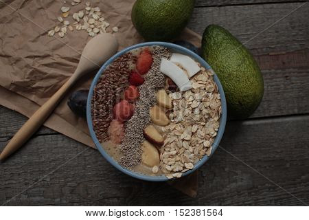 Breakfast berry smoothie bowl topped with raspberries, Chia, flax seeds, coconut, Brazil nut