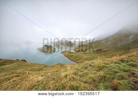 alpine lake in dense fog Bavaria Germany