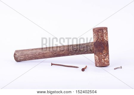 old Sledge hammer and rust nail tack used on white background tool isolated