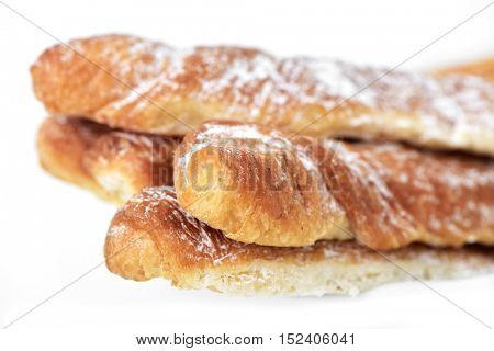 closeup of some fartons, typical pastries of Valencia, Spain, on a white background