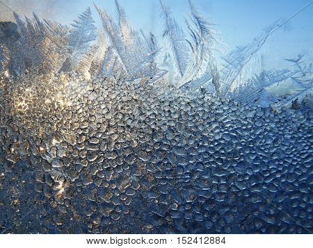Ice pattern and sunlight on winter glass