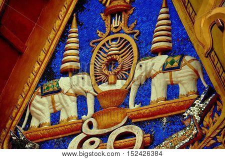 Phuket City Thailand - January 8 2011: Two carved elephant figures decorate the tympanum of a temple pavilion at Wat Mongkhol