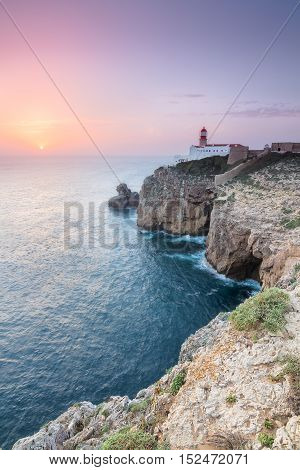 View of the lighthouse and cliffs at Cape St. Vincent at sunset. Continental Europe's most South-western point Sagres Algarve Portugal.