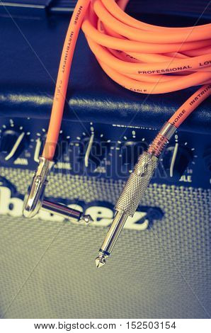 Close-up of guitar amplifier with jack cable.