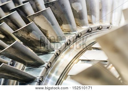 The air compressor of an aircraft engine previously used. Turbine blades closeup. Shallow depth of field.