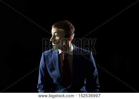 London - UK - 19 October 2016 - Businessman wearing a hacker mask. This mask is a well-known symbol for the online hacktivist group Anonymous