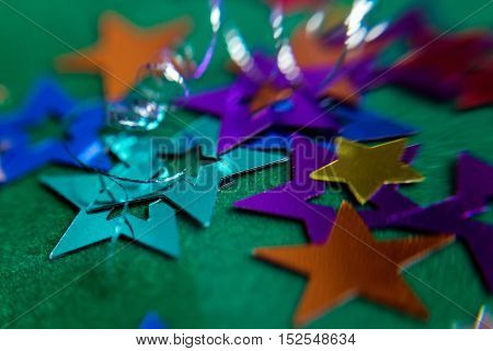 small multi-colored stars on a green background
