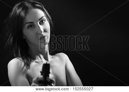 naked woman with black gun aiming at camera, monochrome