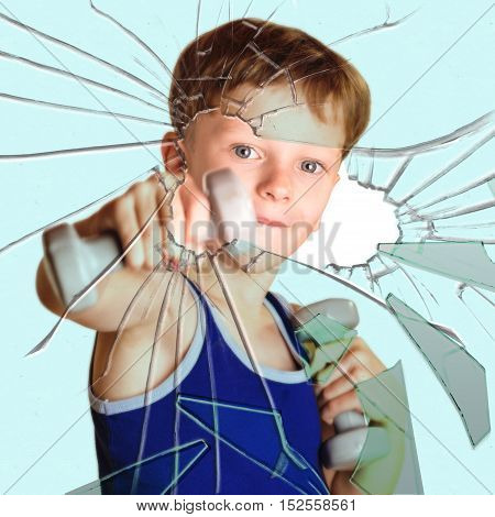 Boy athlete with dumbbells broken glass hand