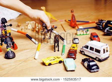 children playing toys on floor at home, little hand in mess, free education, lifestyle people concept