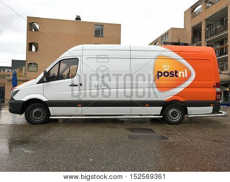Almere Stad, Flevoland, The Netherlands - October 20, 2016: PostNL van by the side of the road in the city of Almere. nobody in the vehicle.