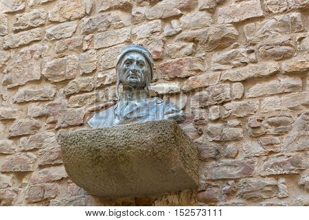 FLORENCE, ITALY - SEPTEMBER 2016 : Bust sculpture of Dante Alighieri's head on brick wall at Dante's House in Florence, Italy on September 21, 2016. Dante is Italian poet of the late Middle Ages