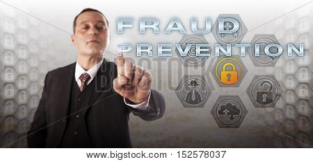 Experienced manager with assertive facial expression is touching FRAUD PROTECTION on a control screen. Information technology concept for civil and criminal computer offense via deliberate deception.