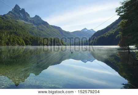 Morning sunrise at misty lake and perfect reflection