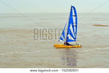 FELIXSTOWE, SUFFOLK, ENGLAND - JUNE 11, 2016: Colorful Dart 16 Catamaran Sailing with 2 crew  at Felixstowe Suffolk England.