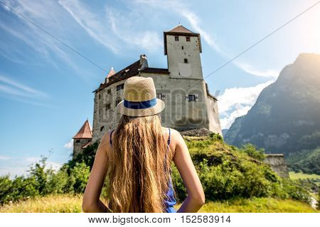 Balzers, Liechtenstein - July 01, 2016: Young female tourist visits Gutenberg castle Balzers town. Gutenberg is one of the five castles of Liechtenstein