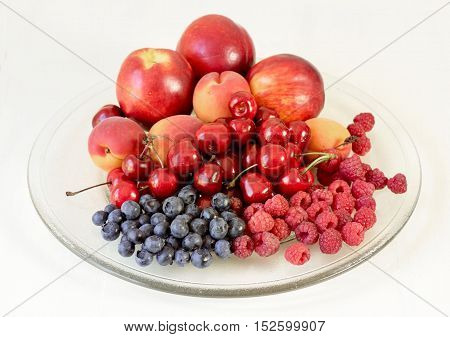 Glass dish with a variety of summer fruit